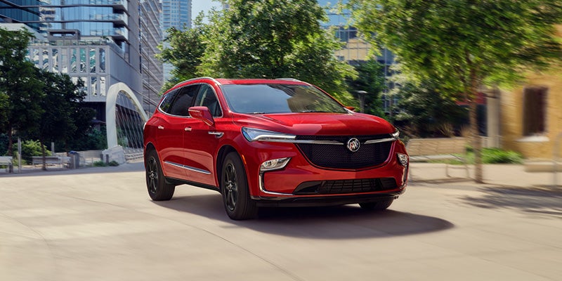2024 Buick Enclave driving by the center of a city