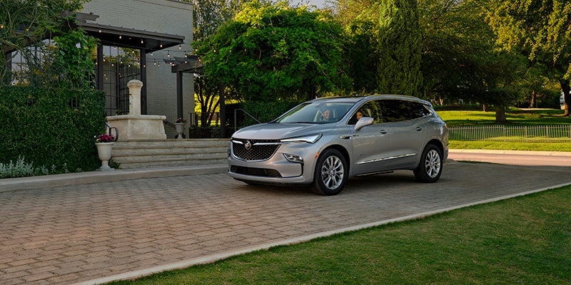 a couple inside of the 2024 Buick Enclave car