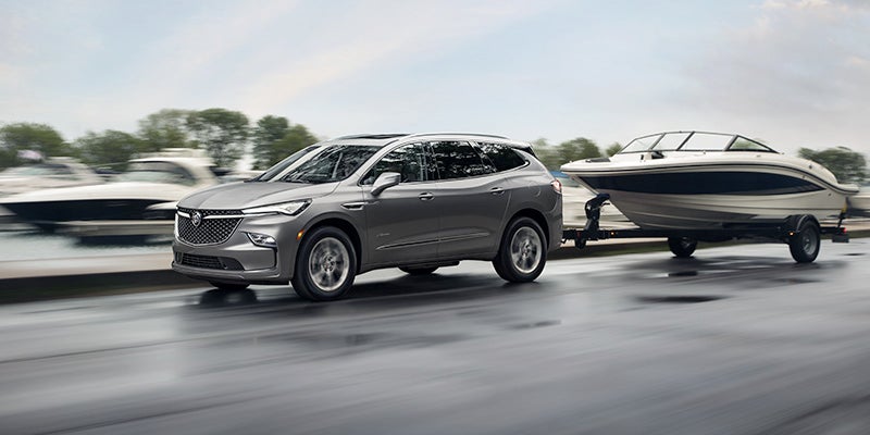 2024 Buick Enclave hitching a boat on the road