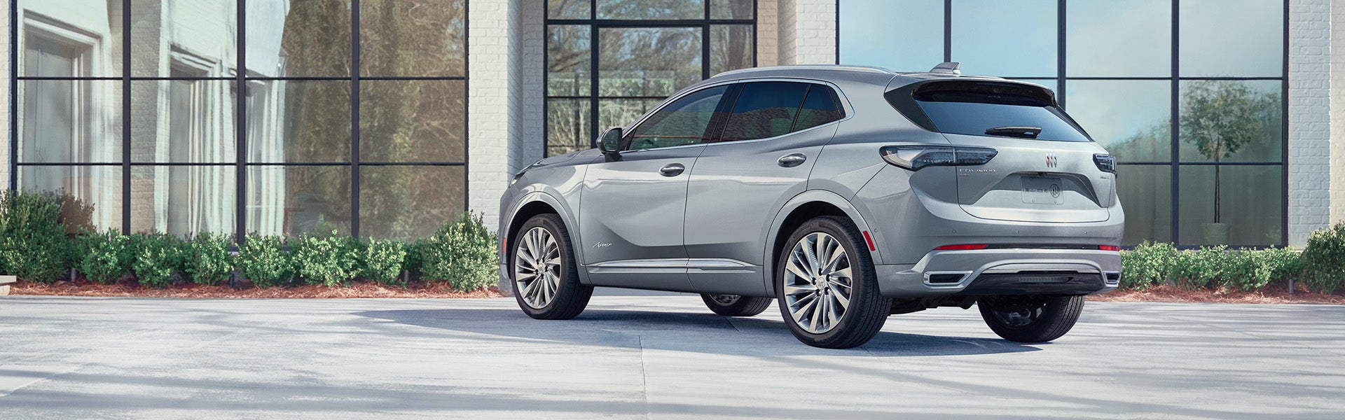 2024 Buick Envison in front of a glass building