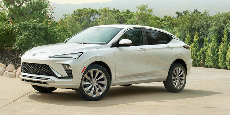 White Buick Envista next to a garden