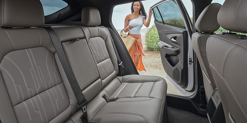 Woman looking inside of a 2024 Buick Envista interior