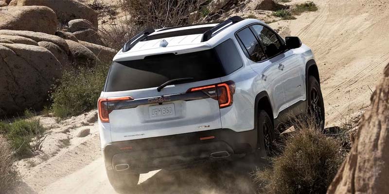2023 GMC Acadia going up hill on a dirt road