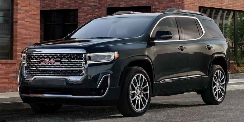 2023 GMC Acadia outside near a building