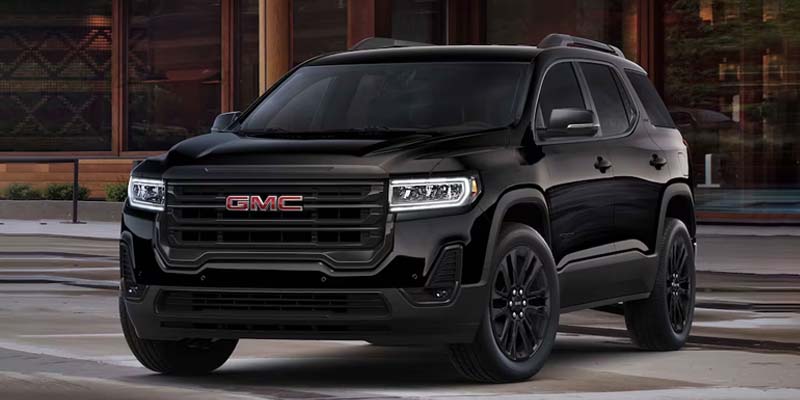 2023 GMC Acadia outside near a building