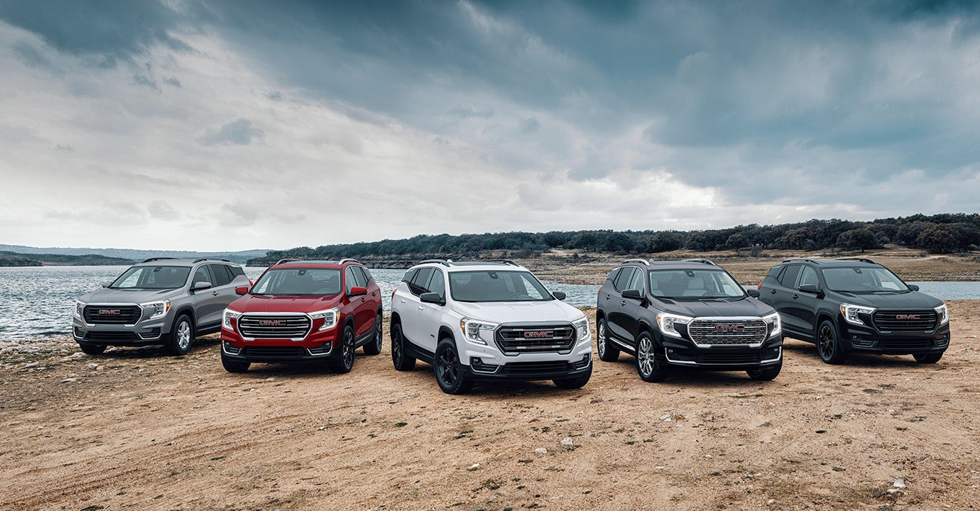 5 2024 GMC Terrain vehicles sitting outside by a lake