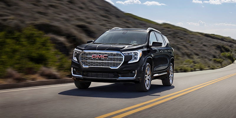 Black 2024 GMC Terrain driving on the road